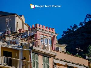 a building with balconies on top of it at La Torretta dei Merli Studio with Unique Views in Vernazza