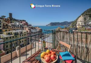 a plate of fruit on a table on a balcony at La Torretta dei Merli Studio with Unique Views in Vernazza