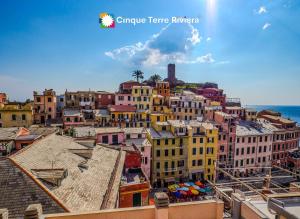 a view of a city with buildings and the ocean at La Torretta dei Merli Studio with Unique Views in Vernazza +35 photos
