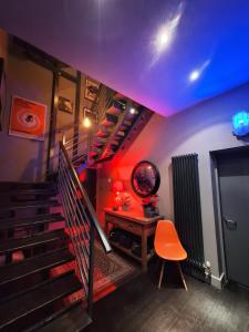 a room with a staircase with a table and a chair at the icecream factory, room in private house in York