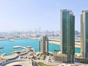 a view of a city with a harbor and buildings at Exclusive Sea-View 2BR Apartment with Fireworks View in New-year eve in Abu Dhabi
