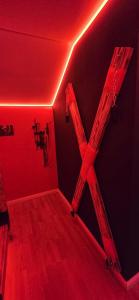 a room with a red room with a cross on the wall at Apartman Fantazy spa BDSM in Novi Grad