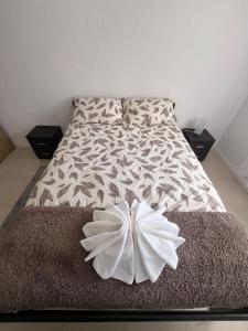 a bed with a white flower on top of it at Latin House in Funchal