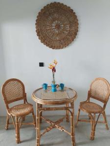a table and two chairs with a table and a mirror at Amma's Garden in Unawatuna