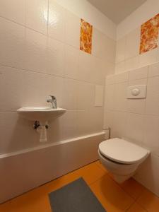 a bathroom with a toilet and a sink and a tub at SOURCE WITHIN - Lipno in Lipno nad Vltavou +6 photos