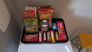 a shelf filled with different types of food and snacks at kitnet Nostradamus in Barão de Cocais