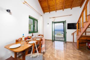a dining room with a table and a view of the ocean at Villa Anastasia in Ieromónachos