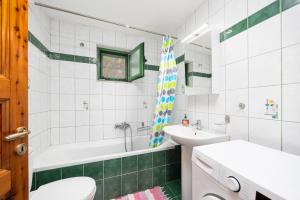 a bathroom with a tub and a sink and a toilet at Villa Anastasia in Ieromónachos +21 photos