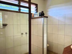 a bathroom with a shower with a glass door at Amazing view in Port Vila +3 photos