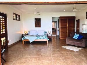 a bedroom with a bed and a couch at Amazing view in Port Vila