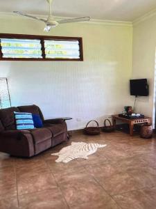 a living room with a couch and a tv at Amazing view in Port Vila