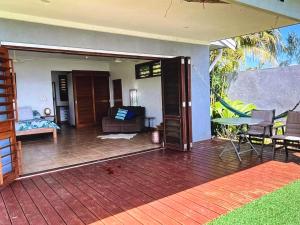 a living room with a patio with a table and chairs at Amazing view in Port Vila