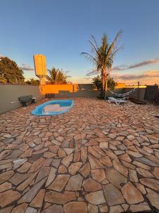 un patio en pierre avec une piscine au milieu dans l'établissement Casa de Brotas com Piscina, à Brotas
