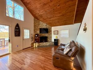 a living room with a couch and a fireplace at Lake Front Sunset | New Deck | Kayaks | Canoe in Salisbury