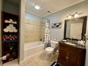 a bathroom with a tub and a toilet and a sink at Lake Front Sunset | New Deck | Kayaks | Canoe in Salisbury +47 photos