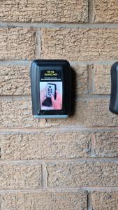 a pay phone is attached to a brick wall at Exceptional 1 bedroom riverside 2E apartment in Ayr