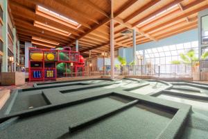 a childrens play area in a building with a playground at MCM Grande FunDome Odessa in Odessa