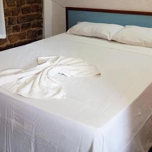 En eller flere senge i et værelse på Pousada Refúgio