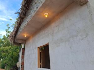 a building with a light on the side of it at Yahweh Guriú in Camocim