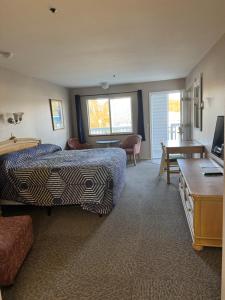a hotel room with a bed and a desk at Bayview Inn in Crescent City