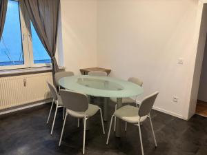 a table and chairs in a room with a window at Duisburg Flats 24 in Duisburg