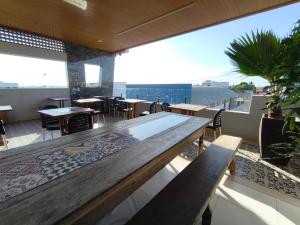 a restaurant with a table and some tables and chairs at Hipolitus Hotel in Lagarto