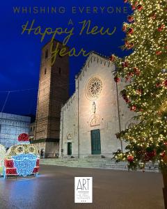 a christmas tree in front of a church at Art Hotel Pietrasanta in Pietrasanta