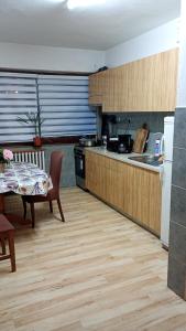 a kitchen with a table and a table and a kitchen with a tableablish at Apartments with balcony and with large free parking House Oliver in Plitvička Jezera