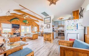 a large living room with wooden floors and a kitchen at This is it - Nags Head MP 16, Ocean View, 75 Yards to Beach, Elevator, Wheelchair Friendly, Flex Stays in Nags Head