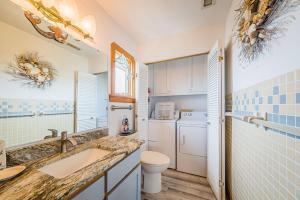 a bathroom with a sink and a toilet at This is it - Nags Head MP 16, Ocean View, 75 Yards to Beach, Elevator, Wheelchair Friendly, Flex Stays in Nags Head +38 photos