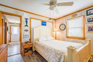 a bedroom with a bed and a clock on the wall at This is it - Nags Head MP 16, Ocean View, 75 Yards to Beach, Elevator, Wheelchair Friendly, Flex Stays in Nags Head