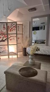 een kamer met een bed en een tafel met bloemen erop bij Basement studio in hosts house with private terrace and BBQ Ideal for The camino in Zizur Mayor