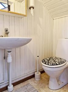 a bathroom with a sink and a toilet at Unikt sommarboende in Färjestaden +20 photos