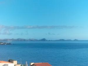 a view of the ocean with mountains in the distance at Villa Atlantic Lodjadis in Gaula