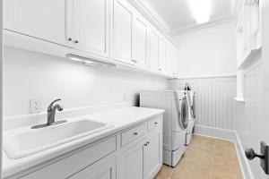 a white kitchen with a sink and a refrigerator at Seagrove Sun in Santa Rosa Beach +45 photos