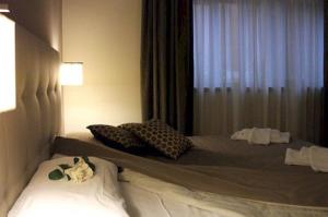 a bedroom with a bed with pillows and a window at Hotel Desiderio in Rome