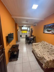 a room with two beds and a living room at Casa quinta in Dolores