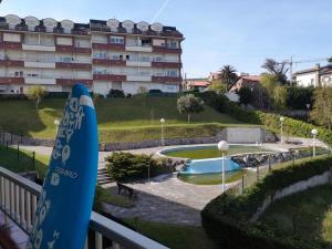 a surfboard on a balcony next to a building at El Sueño del Maestro in Suances