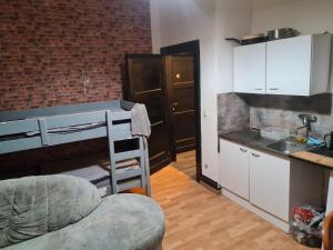 a small kitchen with a sink and a counter at MonteurRoomMR in Essen