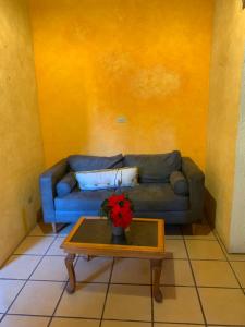 a living room with a blue couch and a coffee table at Casa Díaz in San Miguel de Allende