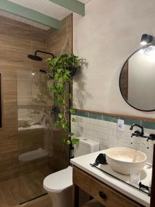 a bathroom with a sink and a toilet and a mirror at Mar de Fondo in La Pedrera +17 photos