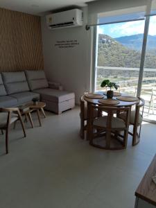 een woonkamer met een tafel en een bank bij doca brisa in Santa Marta