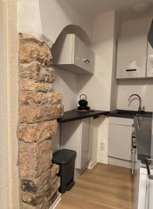a kitchen with a stone wall next to a counter at Ferienwohnung Querfurt in Querfurt +2 photos