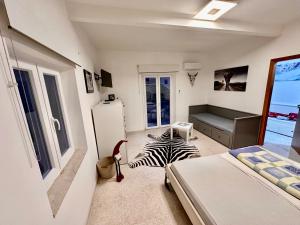 a bedroom with a bed and a zebraebra rug at Fantastic sea & harbour view Nino Bixio in Castellammare del Golfo
