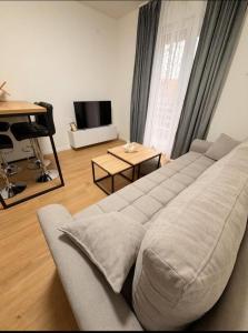 a living room with a couch and a television at Apartman Maras in Posušje