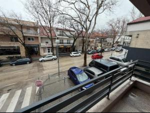 a parking lot with cars parked on a city street at Apartman Maras in Posušje