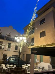 een gebouw met tafels en stoelen voor een gebouw met verlichting bij La Llum de Serra in Serra