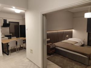 a bedroom with a bed and a dining room at Urban Mountain House in Karpenision