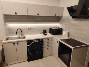 a kitchen with a sink and a washing machine at Urban Mountain House in Karpenisi