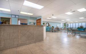 a lobby with a bar and tables and chairs at Phoenix East 1211 in Orange Beach